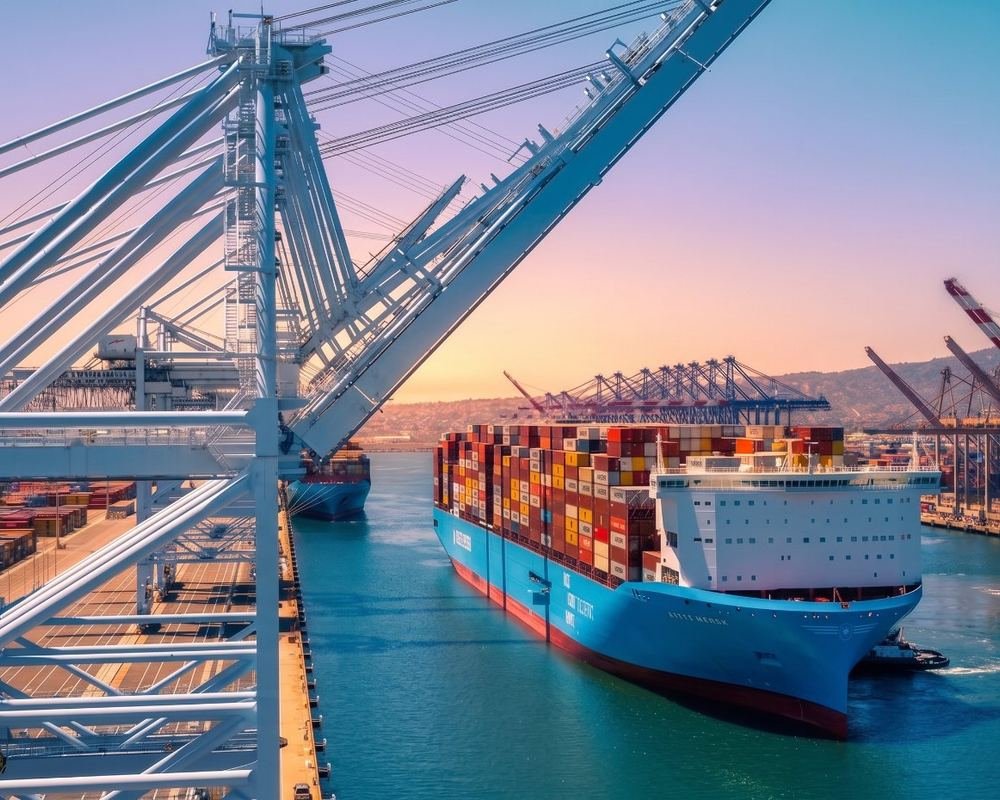 Gantry cranes loading containers onto a cargo ship at a port